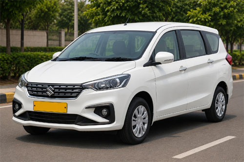 White Maruti Ertiga taxi with yellow commercial plate